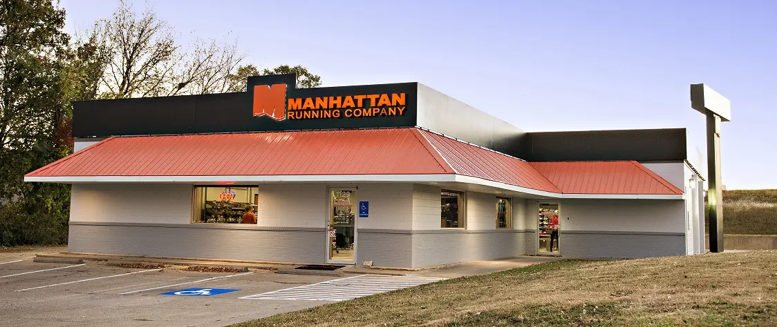 Manhattan Running Company storefront, with the orange roof and sign